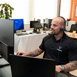 Support staff working with headset and computer