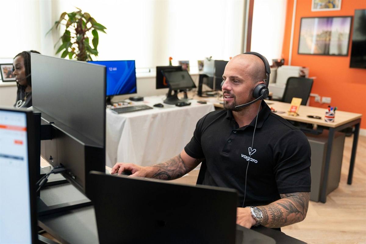 Support staff working with headset and computer