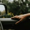 Driver hand on a car steering wheel
