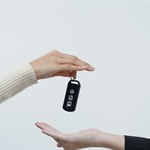 Hands exchanging a vehicle key